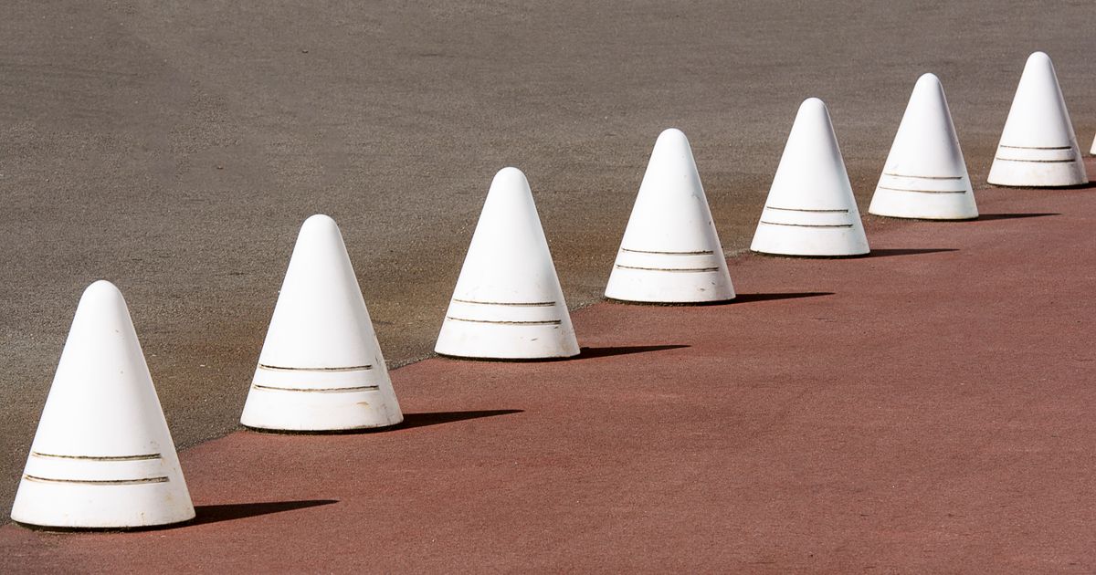 A row of identical white cones