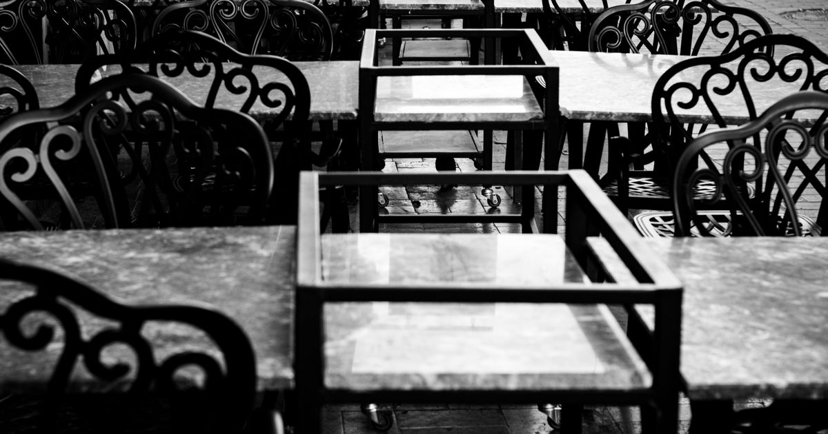 Empty chairs outside a cafe in the morning
